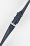 Blue leather watch strap with matching stitching, shown in angled close-up with a silver buckle and adjustment holes.