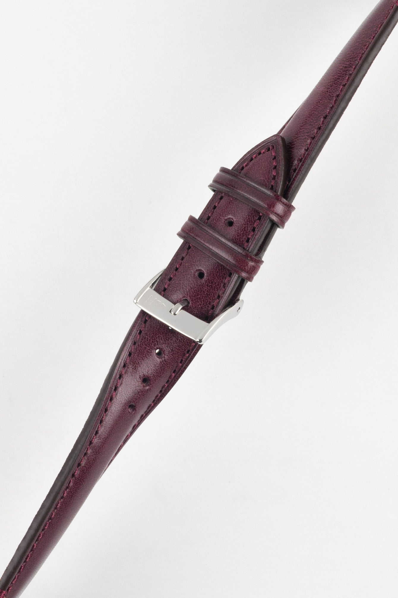 Burgundy leather watch strap with matching stitching, shown in angled close-up with a silver buckle and adjustment holes.