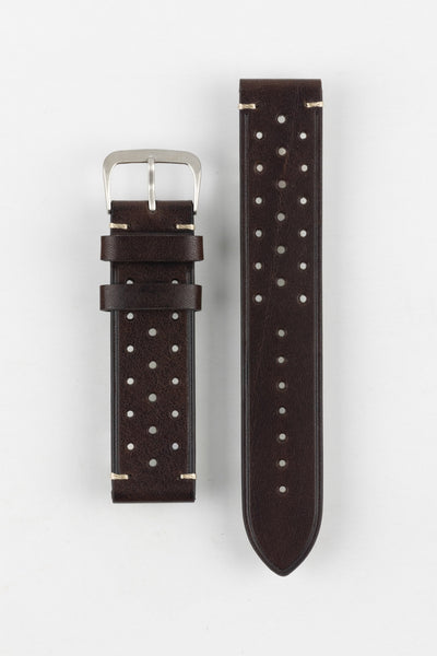 A high-angle studio shot of a dark brown Morellato Brahms watch strap with beige stitching and a stainless steel buckle, laid flat against a white background. The strap features a rally-style design with two rows of perforations.