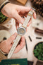 Hands holding Studio Underd0g Bicompax ST-1901 watch with Morellato SCHUMANN beige suede strap. Premium watch strap fitting.