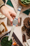 Hands holding a Tudor Black Bay 58 watch with a Morellato SCHUMANN blue suede strap. Easy strap fitting instructions.