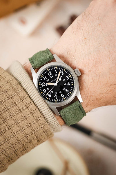 Morellato SCHUMANN green suede watch strap on wrist with a Hamilton Khaki Field watch. Elevate your everyday style with our watch bands.