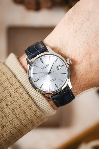 A man's wrist wearing a Seiko Presage watch with a stylish blue Morellato Tiepolo strap.