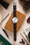 Seiko watch with a brown Morellato Tiepolo watch strap shown on a wooden box, surrounded by watch tools.