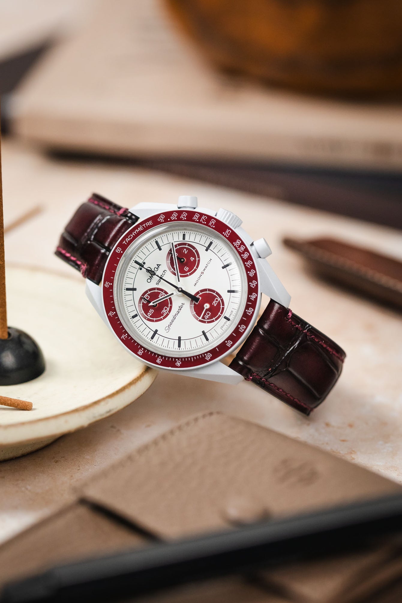 An Omega MoonSwatch watch paired with the rich burgundy Morellato Tiepolo watch strap, an excellent combination.