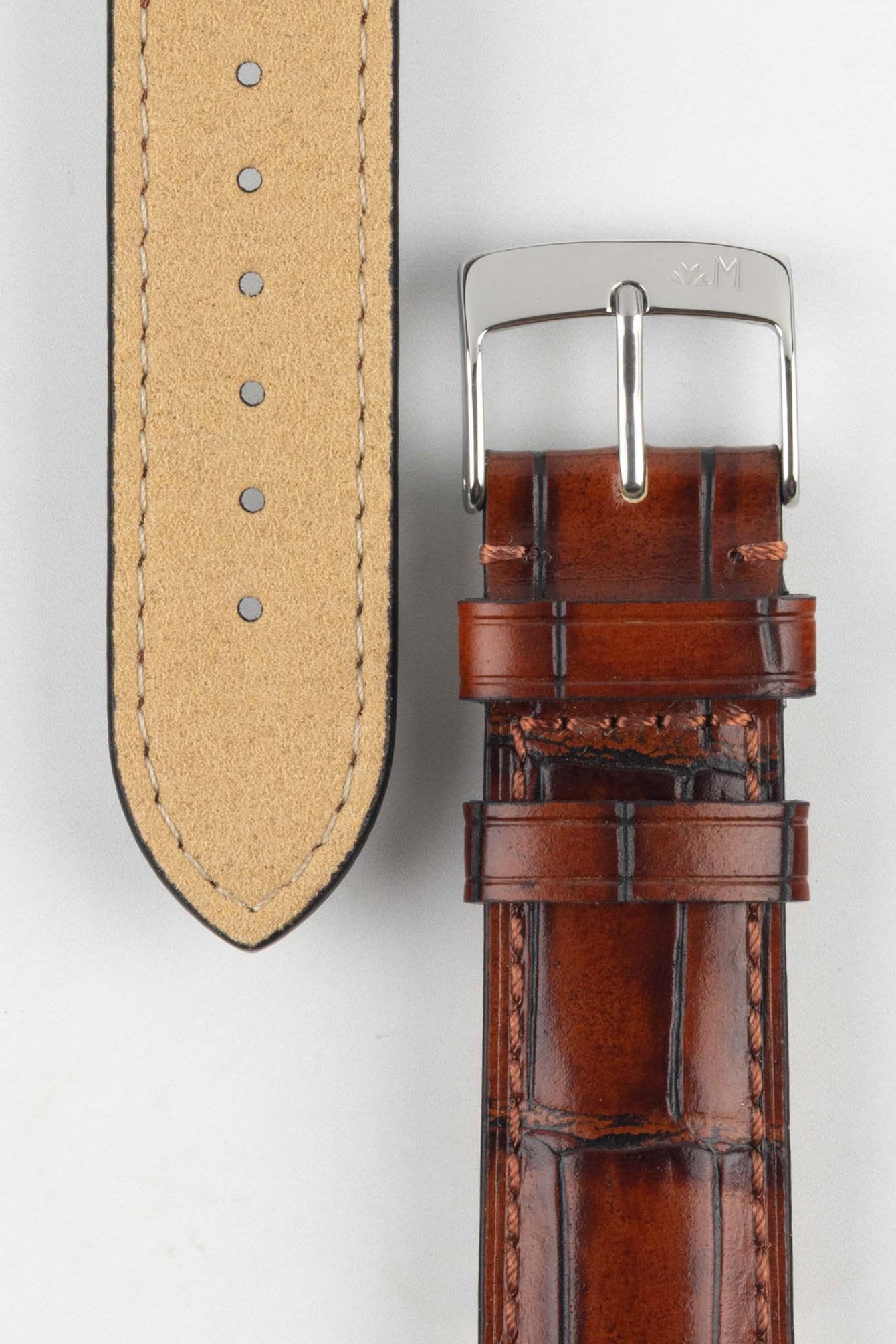 Close-up of the light brown Tiepolo watch strap, highlighting the grain of the leather and the polished silver buckle.