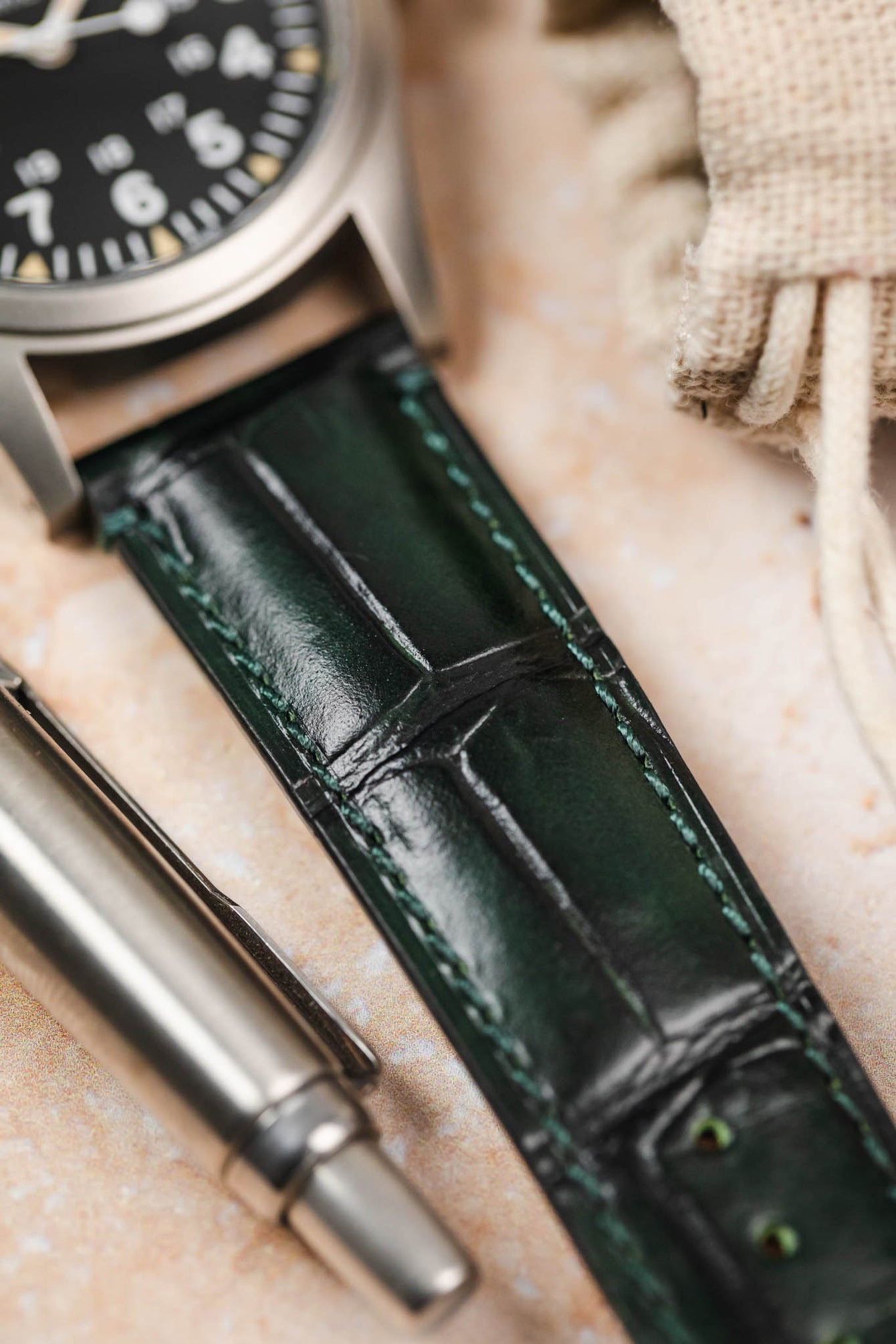 Close-up of a green Morellato Tiepolo watch strap on a Hamilton watch, highlighting the luxurious texture.