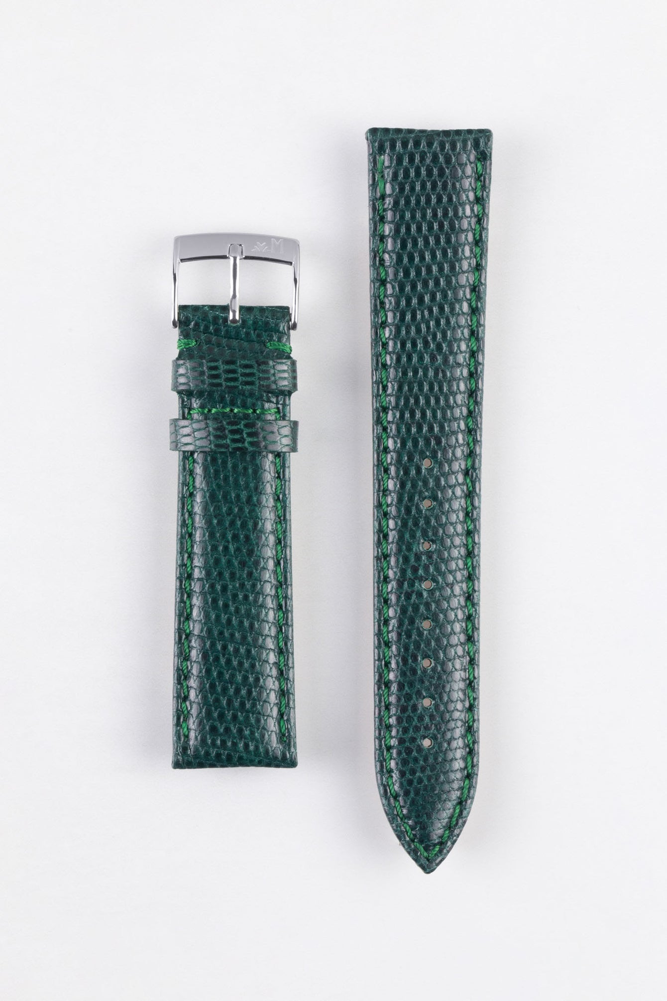 
A top-down flat lay of a two-piece watch strap in a dark green color, featuring a textured, lizard-skin pattern. The strap is presented vertically on a clean white background. The left piece is shorter with a silver-toned buckle, while the right piece is longer and tapered, with visible holes for adjustment and prominent green stitching along its edges.