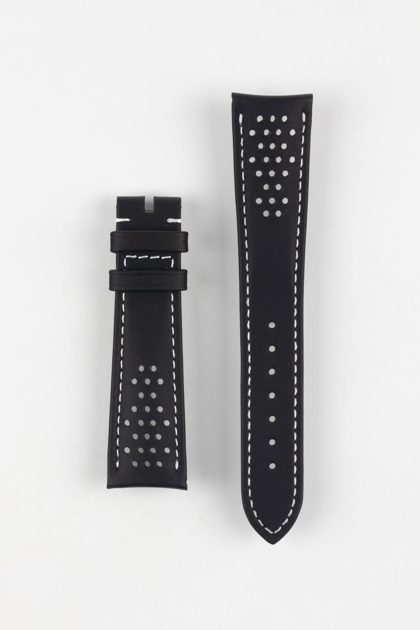 Product shot of a black leather watch strap displayed against a white background, showing both sections separately: one with two keepers and white contrast stitching near the lug end, and the other with a pointed tip, multiple adjustment holes, and perforated detailing, highlighting the smooth finish and sporty design.