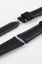 Close-up product image of a black perforated leather watch strap against a white background, showing multiple sections with ventilation holes, white contrast stitching, and the end with two keepers, highlighting the smooth, slightly padded texture and sport-style design.