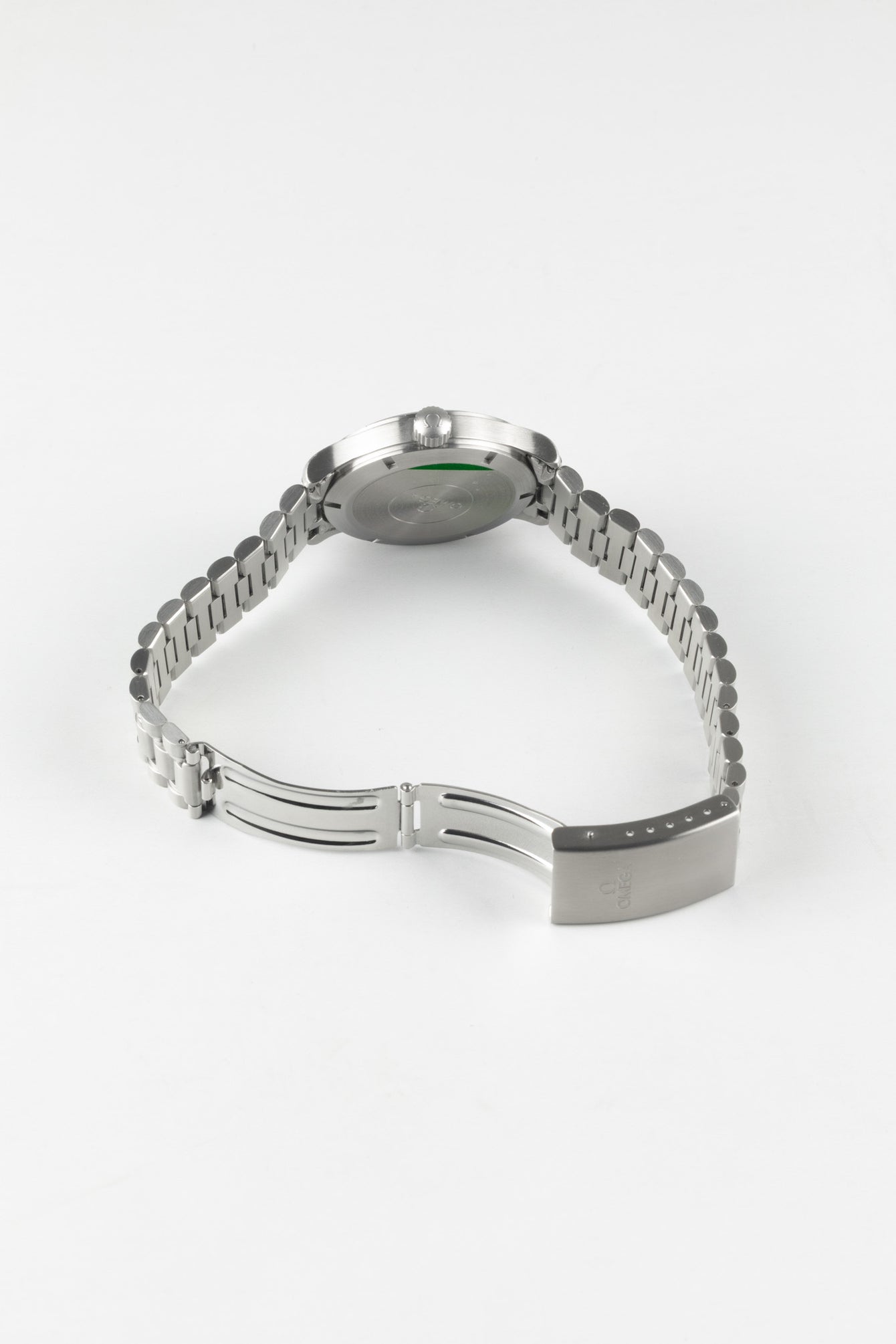 A perspective shot from the rear showing the watch bracelet with the deployment clasp fully open, revealing the internal folding mechanism.