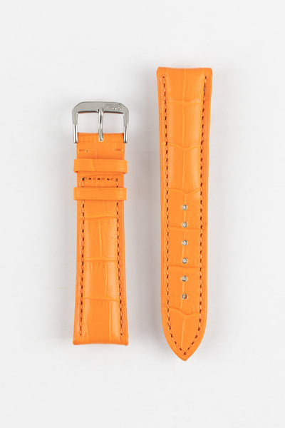 A product shot of an orange crocodile-embossed leather watch strap with a silver buckle. The two separate pieces of the strap are laid vertically side-by-side on a plain white background, and both have tonal stitching.
