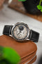 Macro Photography of Studio Underd0g Go0fy Panda Watch on Lambskin Merino Strap in black leant against leather watch case