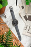 Lay flat image of RIOS1931 Merino Lambskin Leather Watch Strap on Omega Speedmaster Chronograph Watch with black dial
