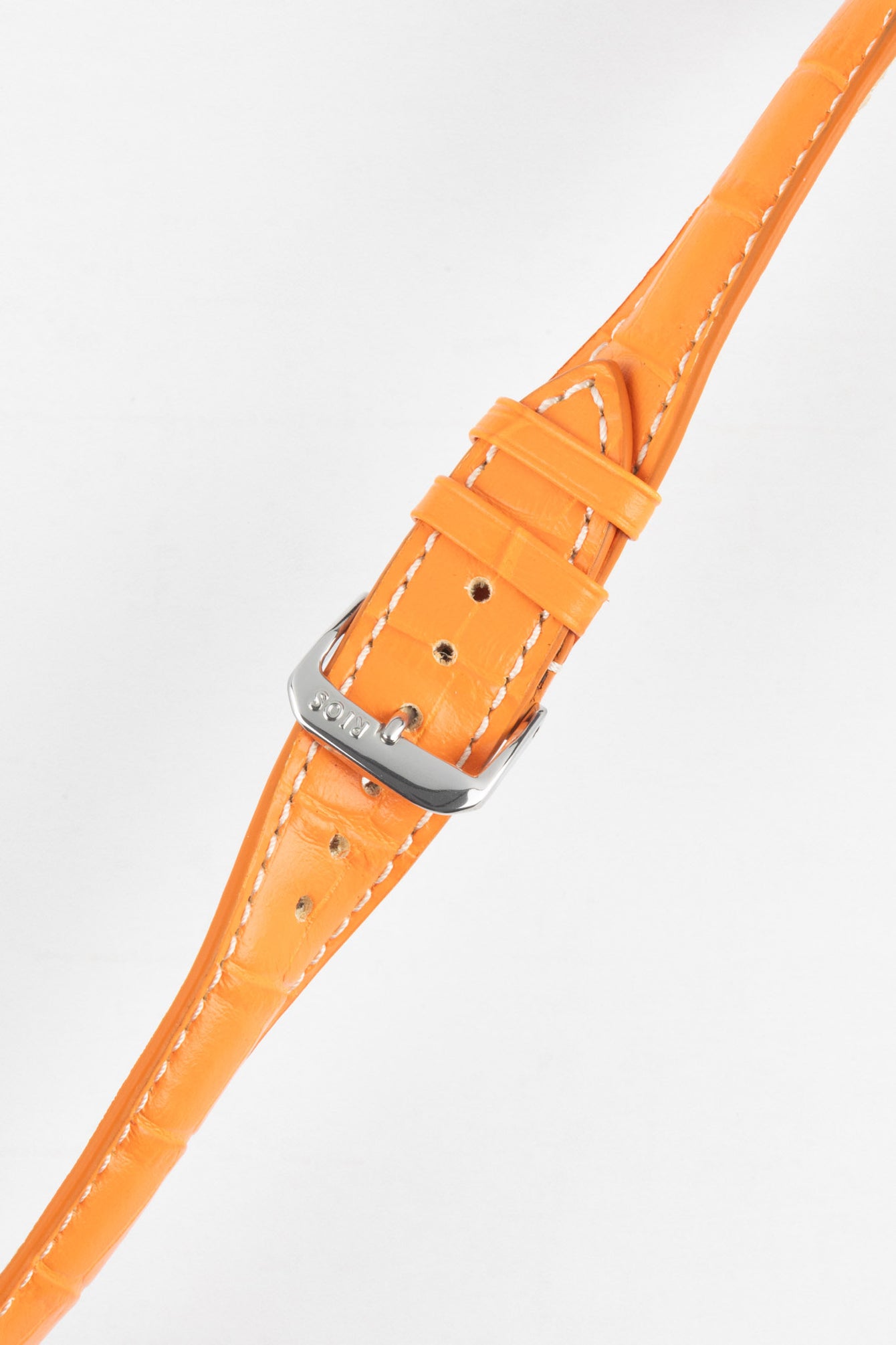 A high-angle product shot of a bright orange crocodile-embossed leather watch strap, buckled and lying diagonally on a plain white background. The strap has white contrast stitching, and the silver buckle is prominently featured.