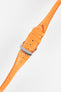 A high-angle product shot of a bright orange crocodile-embossed leather watch strap, buckled and lying diagonally on a plain white background. The strap has white contrast stitching, and the silver buckle is prominently featured.