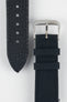 Close-up view of a dark navy watch strap showing both sides on a light gray background. The textured leather underside with adjustment holes and pointed tip is displayed alongside a woven fabric upper section featuring a polished silver-tone RIOS-branded buckle and two matching fabric keepers. The image highlights the strap’s contrasting materials, stitching, and construction details.