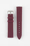 Front view of a burgundy fabric watch strap displayed in two separate pieces on a light gray background. The strap features a woven textile texture, stitched edges, a polished silver-tone RIOS-branded buckle, and two matching fabric keepers. The adjustment section includes six sizing holes and a pointed tip, showcasing the strap’s clean design and durable construction.