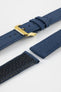 Close-up product image of an ocean blue fabric watch strap displayed in separate sections on a light gray background. The strap features a polished gold-tone RIOS buckle, matching fabric keepers, and stitched edges. A portion of the textured black leather underside is visible, highlighting the contrast between the woven fabric exterior and leather backing, along with the strap's construction and finishing details.