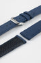 Close-up product image of an ocean blue fabric watch strap displayed in separate sections on a light gray background. The strap features a polished silver-tone RIOS buckle, matching fabric keepers, and stitched edges. A portion of the textured black leather underside is visible, highlighting the contrast between the woven fabric exterior and leather backing, along with the strap's construction and finishing details.