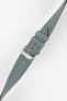 Angled view of a stone grey fabric watch strap with a silver-tone RIOS buckle, adjustment holes, and matching stitched edges.