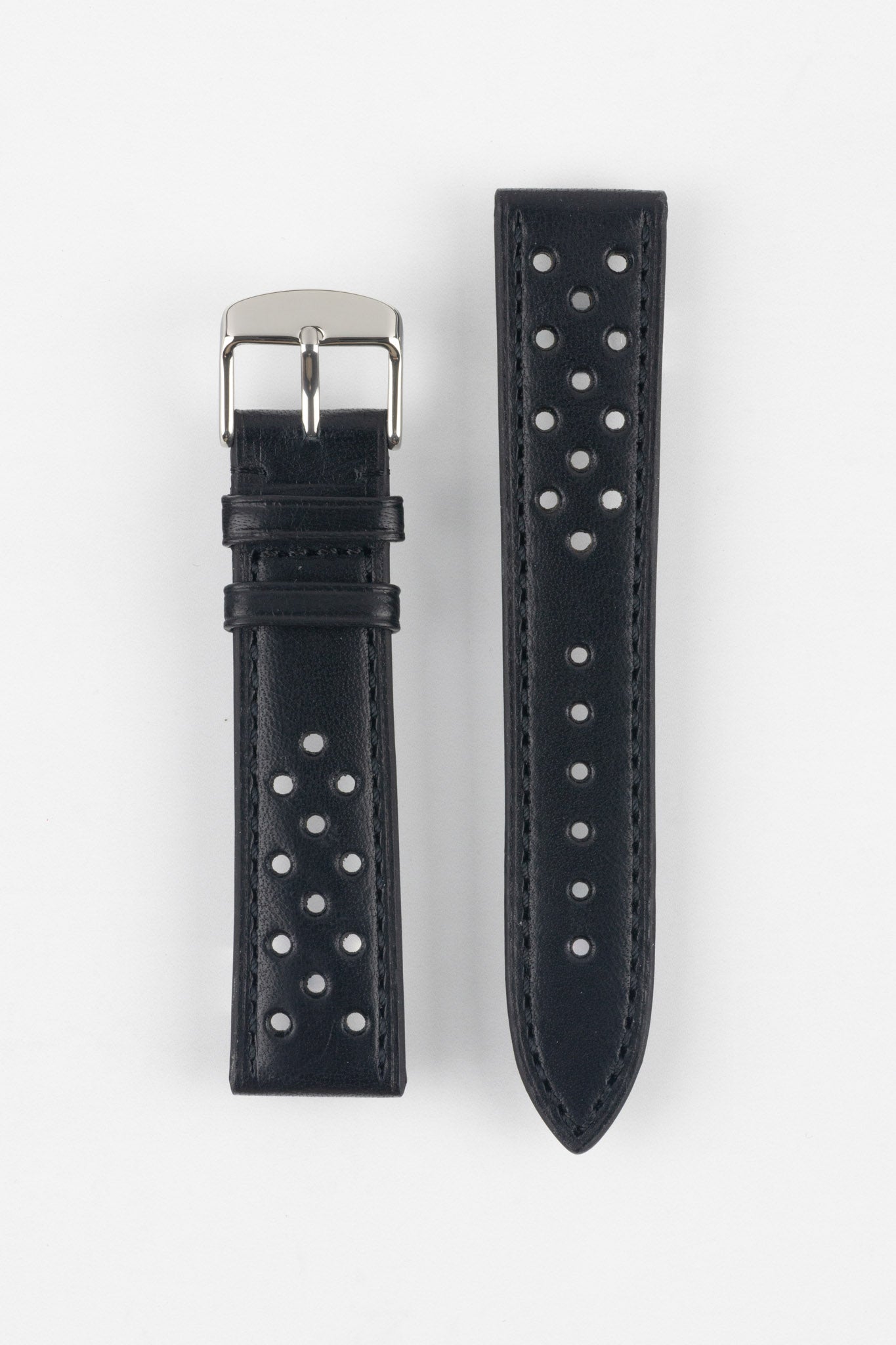 Product shot of a two-piece black perforated leather watch strap laid flat on a plain light background, featuring matching black stitching and a polished silver pin buckle on one end.