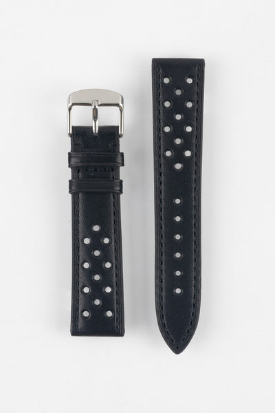 Product shot of a two-piece black perforated leather watch strap laid flat on a plain light background, featuring matching black stitching and a polished silver pin buckle on one end.