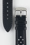 Close-up product shot of a black perforated leather watch strap paired with a separate strap piece, both featuring matching black stitching. A polished silver pin buckle is attached to the main strap, and the components are positioned on a plain light background to highlight the smooth leather texture, perforations, stitching details, and buckle hardware.