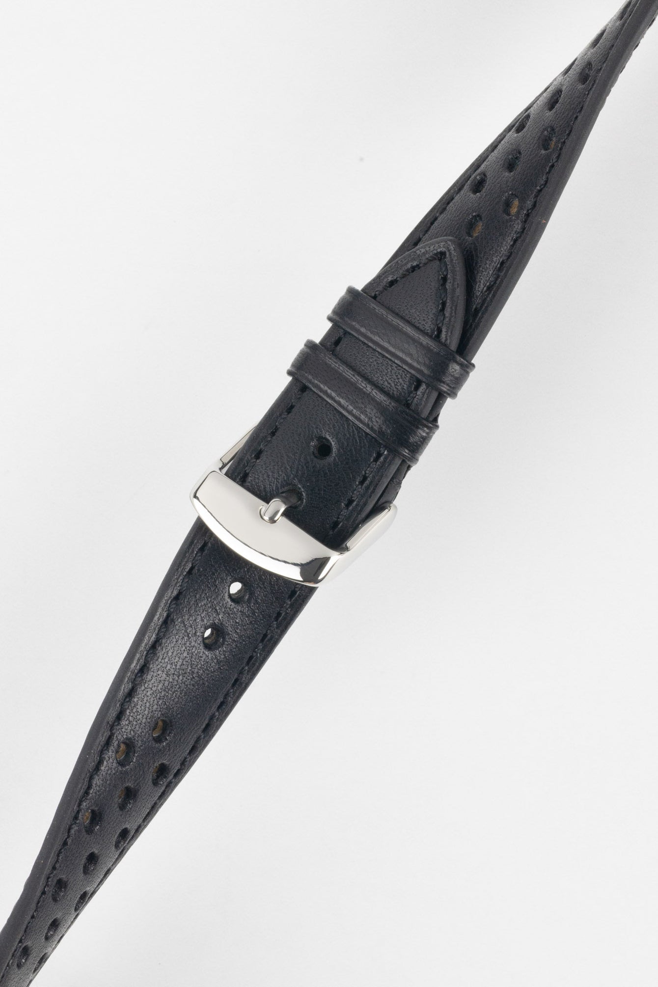Close-up product shot of a black perforated leather watch strap with matching black stitching, fitted with a polished silver pin buckle. The strap is shown at an angle on a plain light background, highlighting the smooth leather finish, perforation pattern, stitching detail, and buckle hardware.