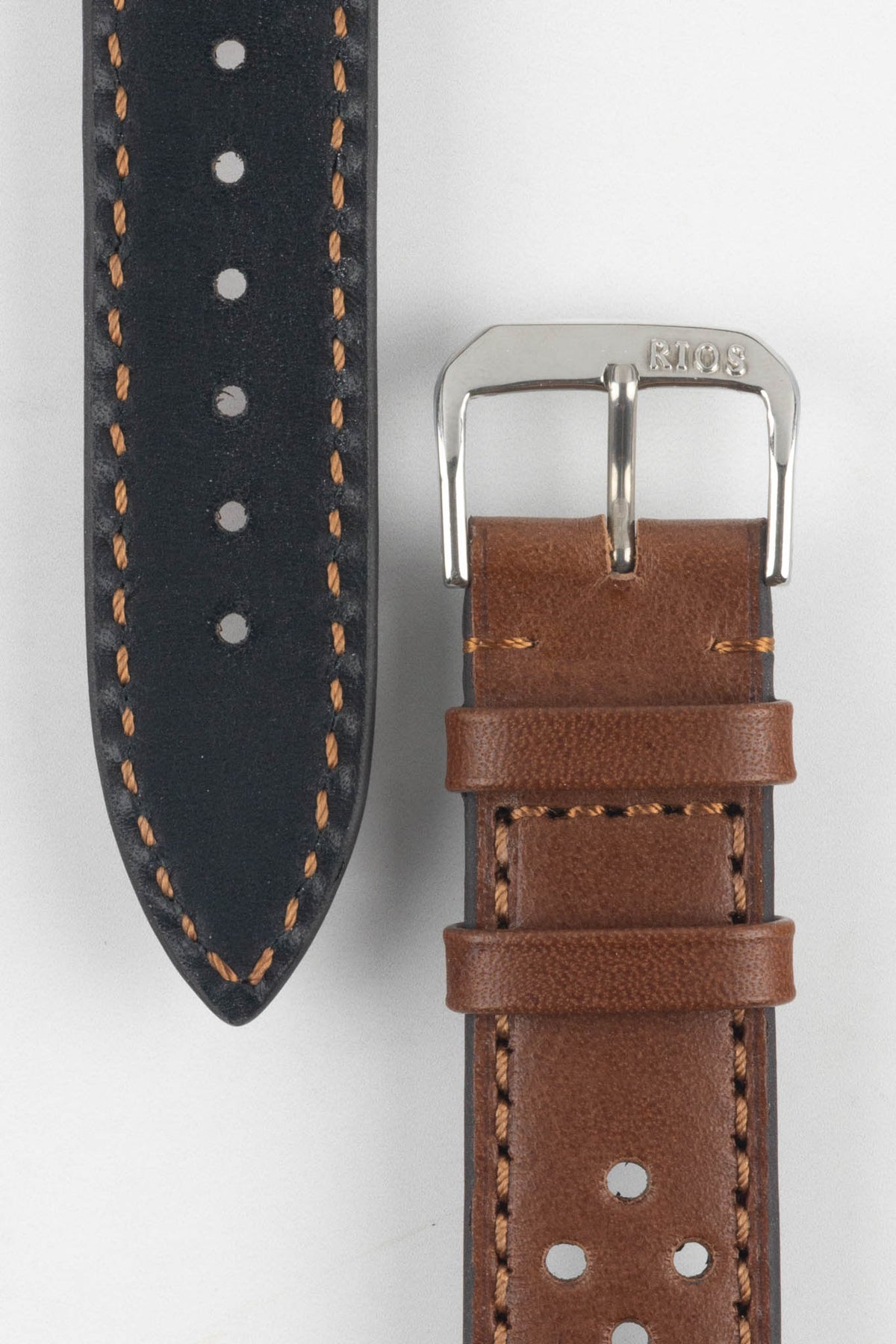 Front and back detail view of a cognac brown perforated leather rally watch strap featuring matching brown stitching, a black leather lining, dual keeper loops, and a polished stainless steel RIOS buckle, displayed on a light grey background to highlight the vintage motorsport-inspired design, contrasting underside, and premium handcrafted construction.