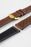 Close-up product shot of brown perforated leather watch strap components with contrast stitching, including one fitted with a polished gold-tone deployment clasp. Additional strap sections, including one with a black underside, are arranged on a plain light background to highlight the leather texture, perforations, and metal hardware details.