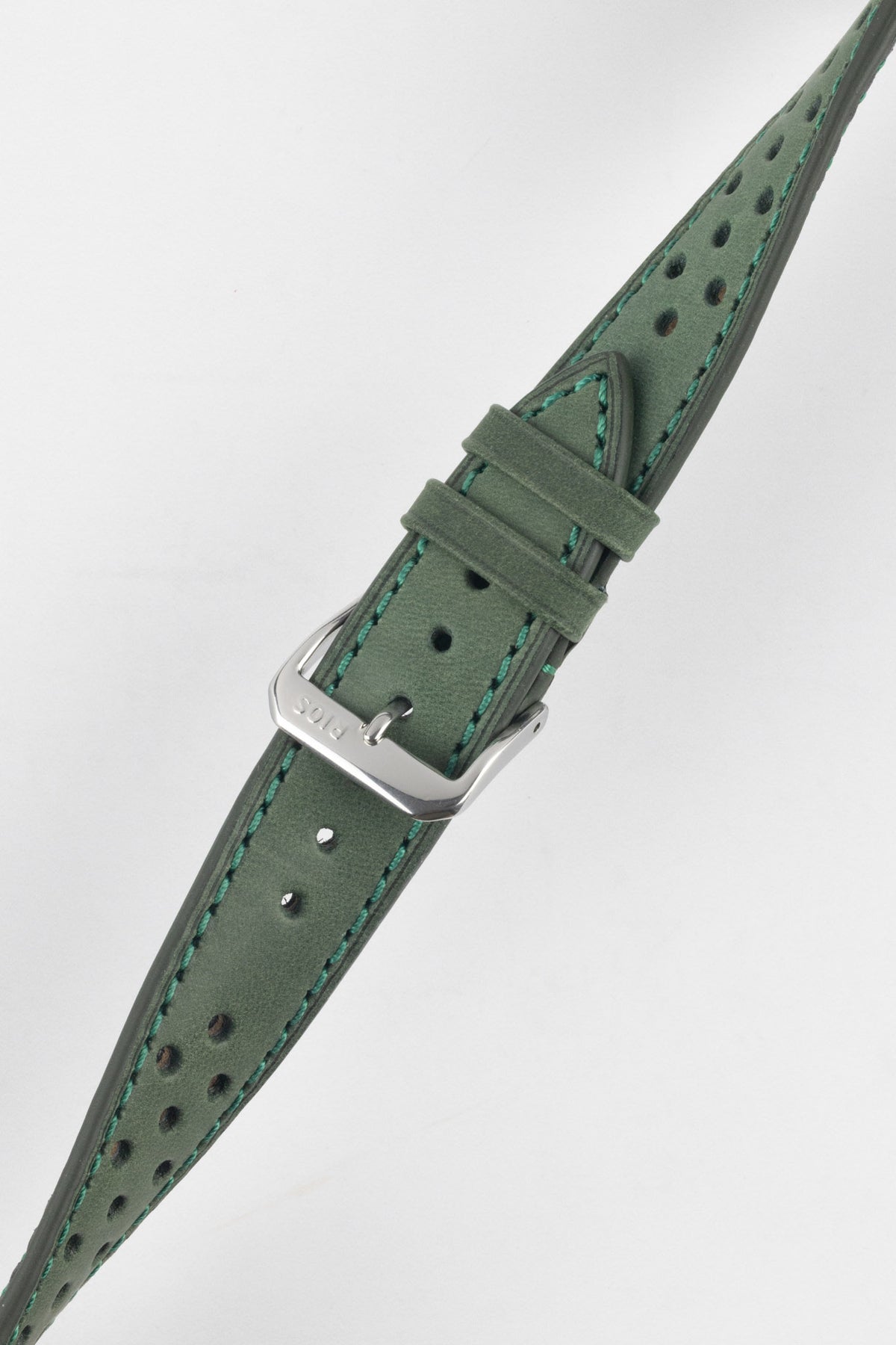 Forest green perforated leather rally watch strap with a soft nubuck-style finish, turquoise contrast stitching, dual keeper loops, multiple adjustment holes, a polished stainless steel RIOS buckle, and a tapered pointed tip, displayed diagonally on a light grey background to highlight the vintage motorsport-inspired design, premium handcrafted construction, and suede-like leather texture.