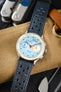 Close-up of a Studio Underd0g Bicompax mechanical chronograph watch featuring a textured light blue dial with contrasting cream sub-dials, polished stainless steel case, and an ocean blue perforated leather rally strap with matching blue stitching. Displayed on a canvas tool roll alongside a multitool and leather accessories, the image highlights the strap's soft nubuck-style texture, motorsport-inspired perforations, vibrant blue colour, and premium handcrafted construction.