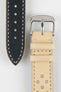 Close-up product shot of a beige perforated leather watch strap paired with a black underside strap segment, both featuring contrasting stitching. A polished silver pin buckle is attached to the beige strap, and the pieces are arranged on a plain light background to highlight texture, perforations, and finishing details.