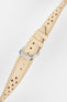 Sand-coloured perforated leather rally watch strap with cream contrast stitching, dual keeper loops, multiple adjustment holes, a polished stainless steel RIOS buckle, and a tapered pointed tip, displayed diagonally on a light grey background to highlight the vintage motorsport-inspired design, premium handcrafted leather construction, and racing-style perforations.