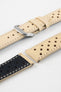 Close-up detail view of a sand-coloured perforated leather rally watch strap displayed with one strap section detached, featuring cream contrast stitching, multiple racing-style perforations, dual keeper loops, a polished stainless steel RIOS buckle, quick-release spring bars, and a black leather lining. Displayed on a light grey background to highlight the vintage motorsport-inspired design, premium handcrafted construction, and contrasting underside.