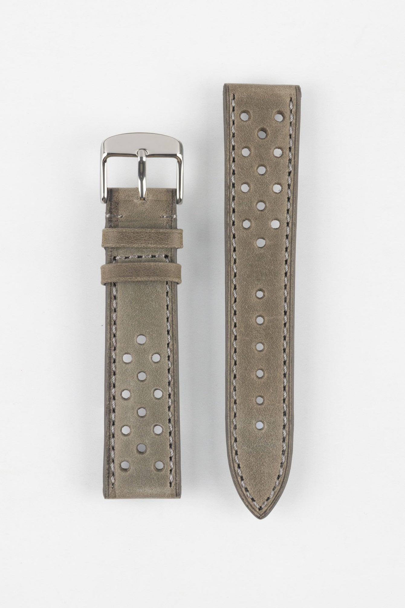 Product shot of a two-piece grey suede perforated leather watch strap laid flat on a plain light background, featuring light contrast stitching and a polished silver pin buckle on one end.