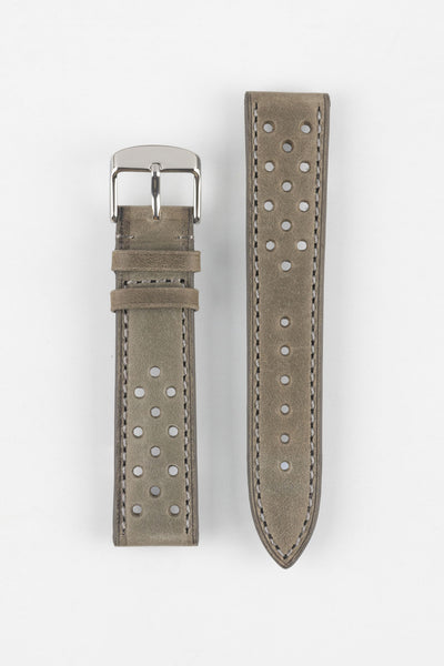 Product shot of a two-piece grey suede perforated leather watch strap laid flat on a plain light background, featuring light contrast stitching and a polished silver pin buckle on one end.