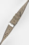 Close-up product shot of a grey suede leather watch strap with perforations and light contrast stitching, fitted with a polished silver pin buckle. The strap is laid at a slight diagonal on a plain light background, highlighting the soft texture, stitching detail, and buckle hardware.