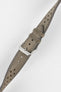 Stone grey perforated leather rally watch strap with a soft nubuck-style finish, tonal grey stitching, dual keeper loops, multiple adjustment holes, a polished stainless steel RIOS buckle, and a tapered pointed tip, displayed diagonally on a light grey background to highlight the vintage motorsport-inspired design, premium handcrafted construction, and textured suede-like leather finish.