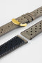 Close-up product shot of grey suede perforated leather watch strap components with light contrast stitching, including one fitted with a polished gold-tone deployment clasp. Additional strap pieces, including one with a black underside, are arranged on a plain light background to highlight the perforations, soft texture, and metal hardware.