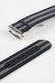Angled close-up of a black ribbed nylon watch strap with alternating grey stripes, featuring a brushed silver deployant clasp with an engraved logo. A separate strap section shows a dark reinforced panel with evenly spaced adjustment holes, all displayed on a light grey background.