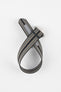Striped ribbed nylon watch strap in black, grey, and cream tones, shown looped and crossed over itself on a light grey background, featuring a brushed silver deployant clasp with an engraved logo and visible adjustment holes along one section.