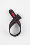 Black ribbed nylon watch strap with a central red stripe, displayed looped and crossed on a light grey background. The strap features a brushed silver deployant clasp with an engraved logo and a red reinforced section with adjustment holes along the underside.