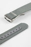 A three-quarter view of a grey ribbed-nylon watch strap fastened into a loop, highlighting the brushed metal buckle and woven texture on a white background.