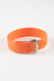 Close-up of a bright orange ribbed nylon watch strap arranged in a loop on a light grey background. The strap features a textured woven finish and a brushed silver deployant clasp with an engraved logo. An orange reinforced section with evenly spaced adjustment holes is visible near the clasp, highlighting the bold color and durable construction.