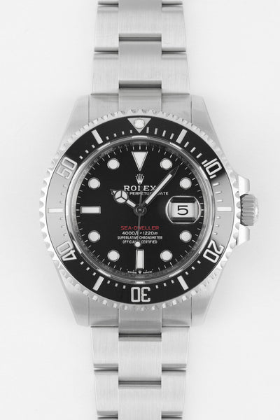 Front view of a stainless steel Rolex Sea-Dweller watch with black dial, luminous hour markers, date magnifier, and rotating bezel, displayed against a plain white background.