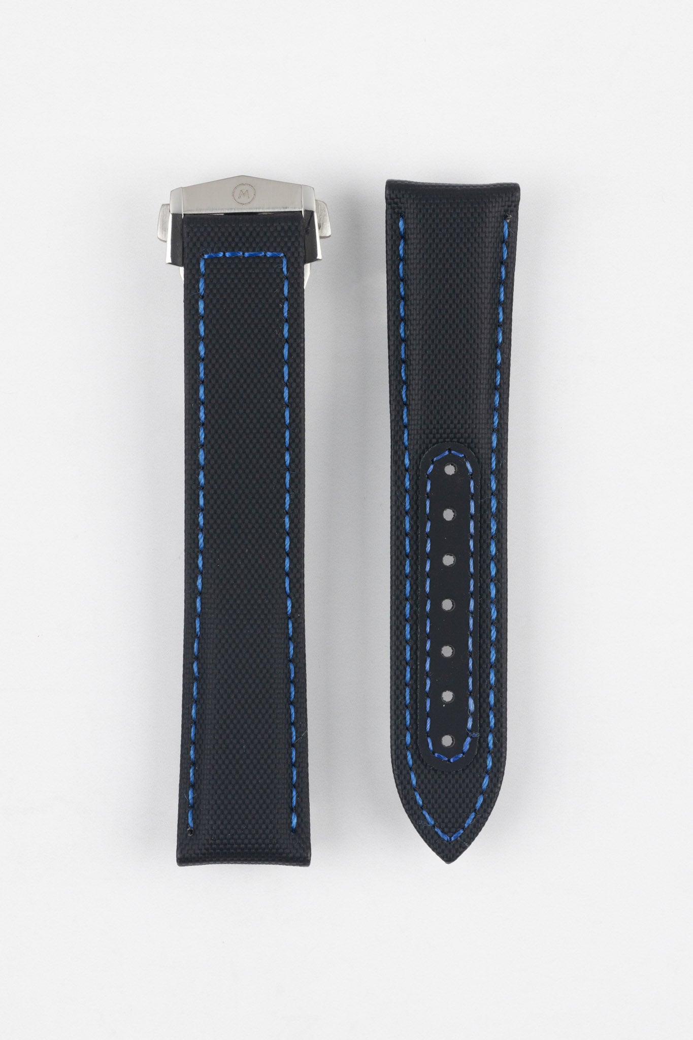 Two black textured watch strap pieces with blue contrast stitching displayed side by side on a light grey background; one strap is attached to a brushed silver deployant clasp with an engraved logo, while the other features a row of adjustment holes.