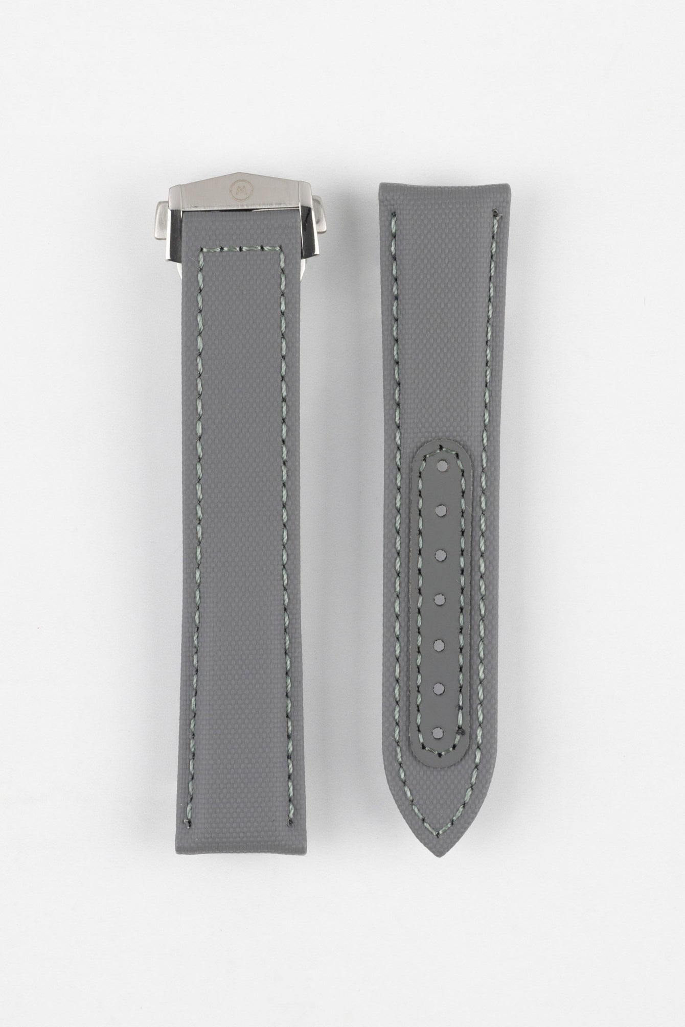 Two grey textured watch strap pieces displayed vertically on a light grey background, featuring subtle light grey stitching; one strap is fitted with a brushed silver deployant clasp with an engraved logo, while the other shows a row of evenly spaced adjustment holes down the center.