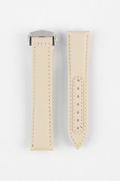 Two sand-colored textured watch strap pieces displayed vertically on a light grey background, featuring matching light stitching; one strap is fitted with a brushed silver deployant clasp with an engraved logo, while the other shows a row of evenly spaced adjustment holes along the center.